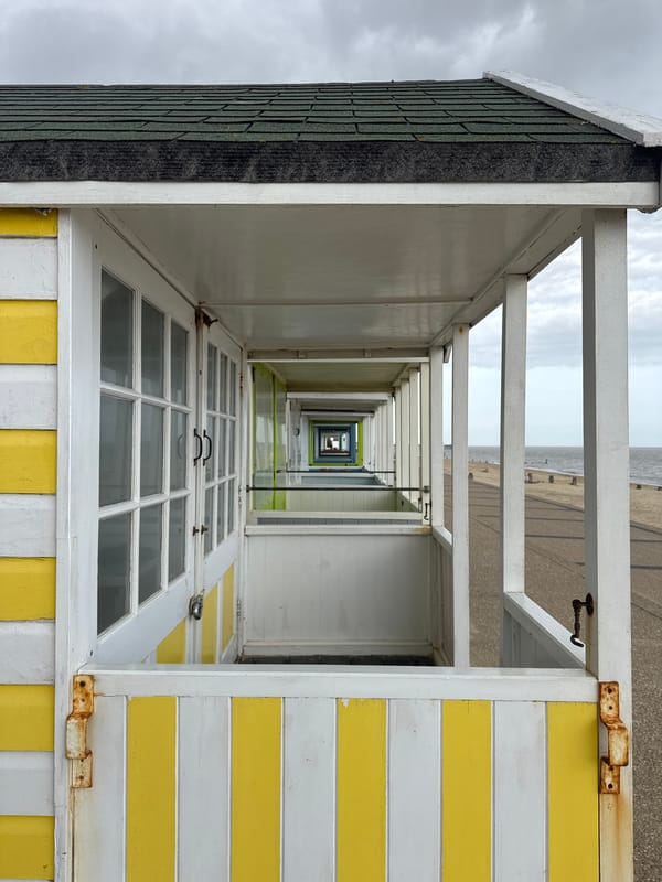 Beach huts lined up along East Suffolk coast