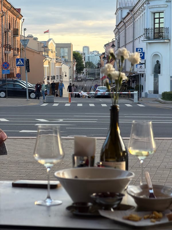 Afternoon drinks at a Minsk café terrace, street life below