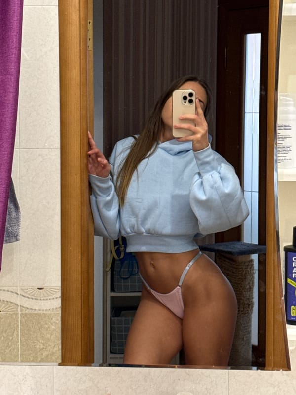 Woman takes bathroom mirror selfie in Zanevka, Russia