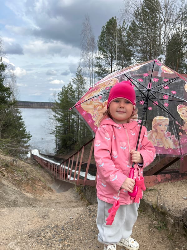 Family visits rushing waterway in Chernushka, Russia