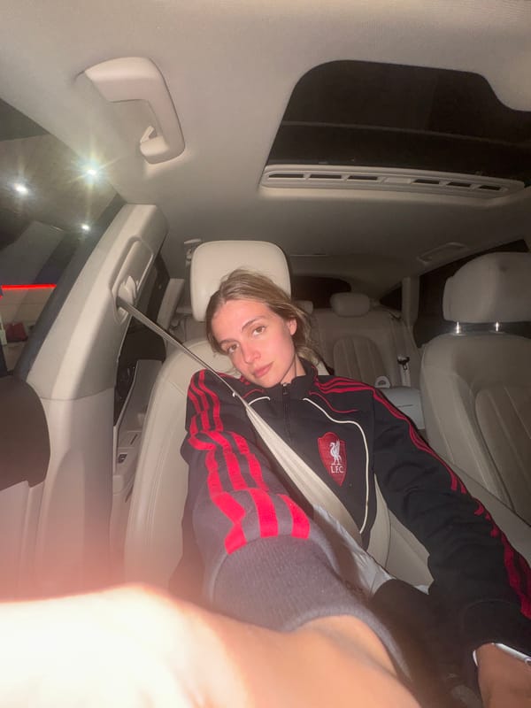 Young person rests in car backseat in Tbilisi