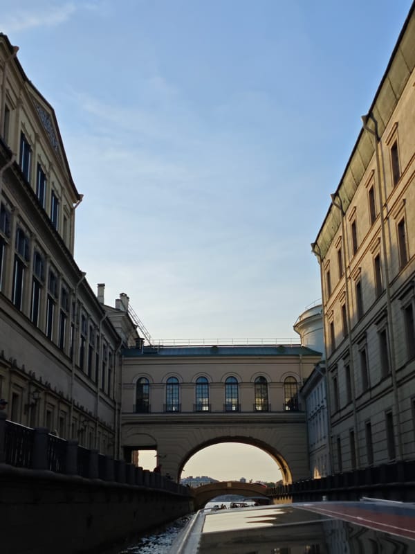 Canal boat journey past classical yellow building documented