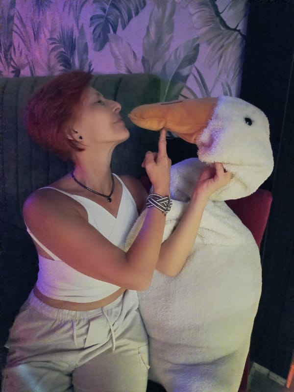 Woman plays with stuffed goose while relaxing in Moscow