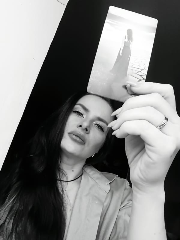 Woman poses with card in portrait session, Rusalevka