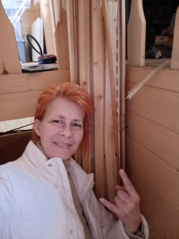 Woman makes rock gesture in unfinished Kommunarka building