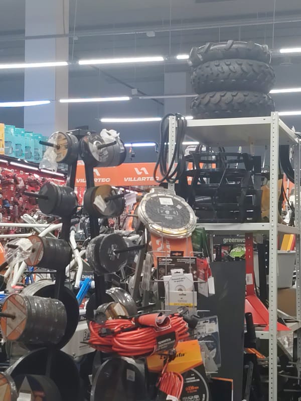 Hardware store floor packed with outdoor power equipment and electric vehicles