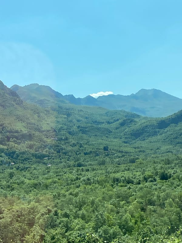 Clear skies over green mountain landscape near Sotonići, Montenegro