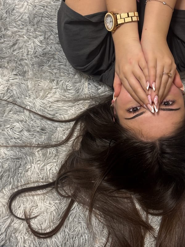 Woman lies on rug with hands over face in Lehchevo