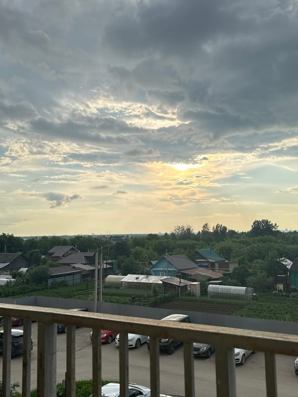 Balcony views of Kondratovo village under dramatic evening skies