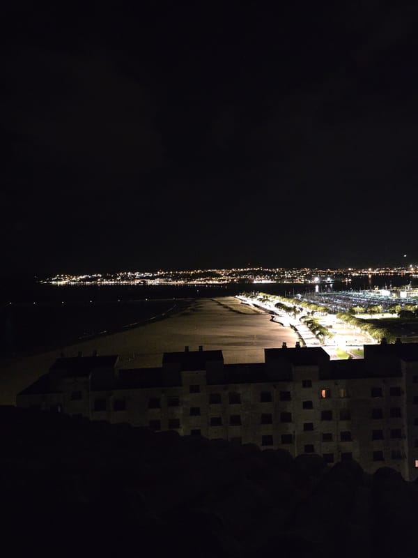 Night view captured of illuminated Hondarribia from elevated vantage point