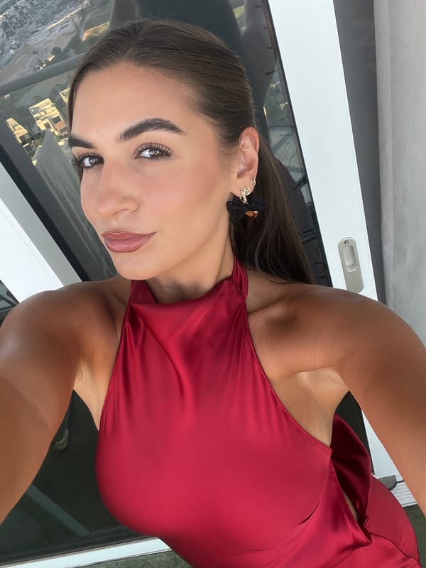 Woman poses for photos against Dubai skyline backdrop