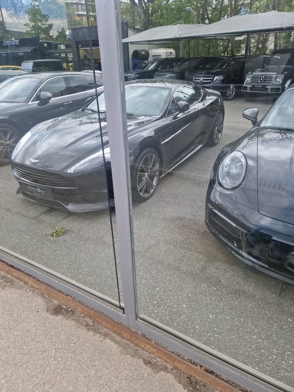 Luxury cars spotted at urban dealership during morning hours