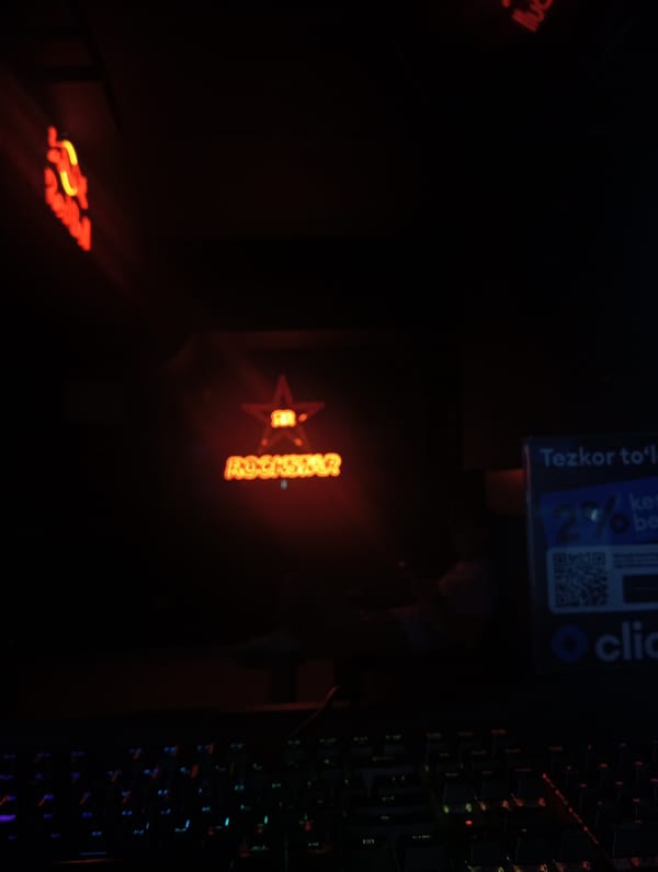 Casual indoor gathering documented near vending machine in Tashkent