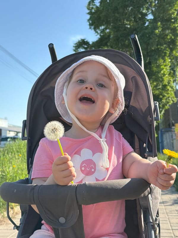 Child and woman enjoy dandelions on sunny Chaikovsky afternoon