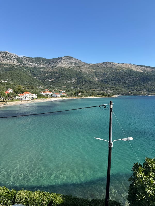 Rocky swim spot on Thassos coast, turquoise water, bright summer morning