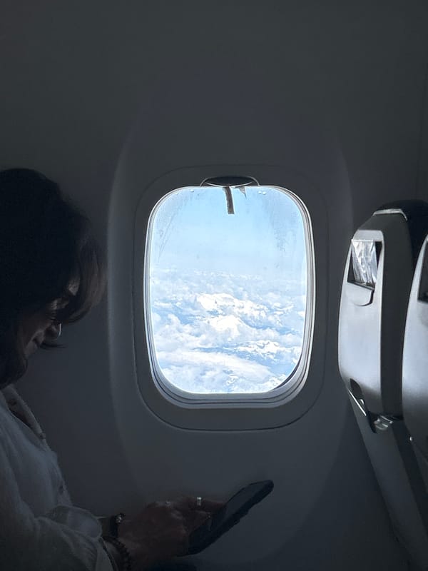 Passenger observed gazing at clouds from airplane window over Canada