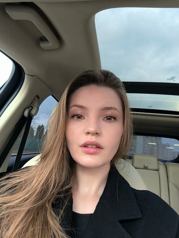 Woman takes selfies in car during rainy day in Vinnytsia