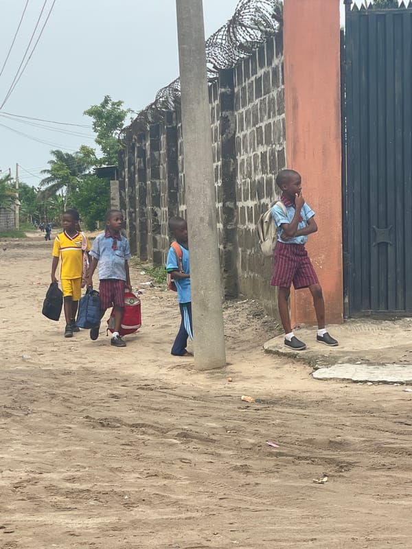 School children walk through Badagry streets during afternoon hours