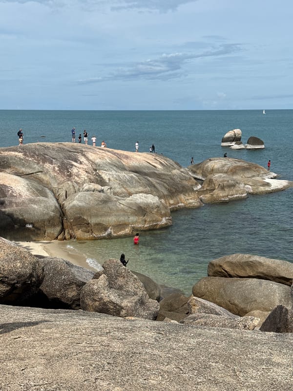 Morning hangout on the boulder-strewn shore of Baan Hua Thanon