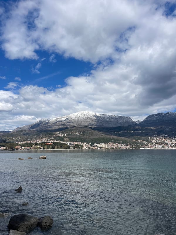 Snow-covered mountains and calm waters observed in Montenegro