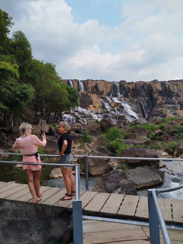 Tourists explore Pongour Waterfall during morning visit in Vietnam