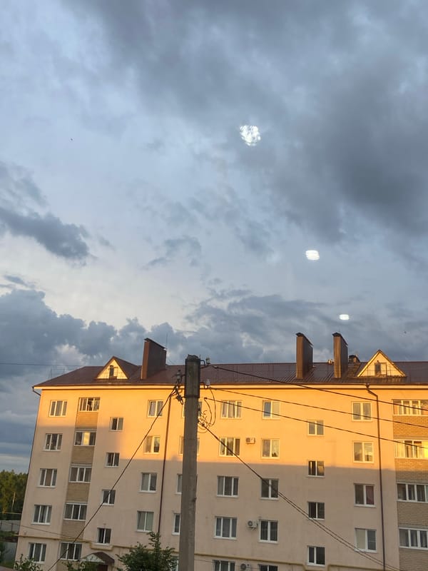 Tujmazy sunset watched across streets, rooftops, and open sky