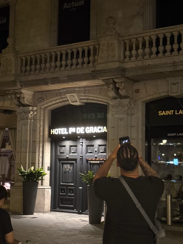 Tourist documents Barcelona architecture and street life during evening walk