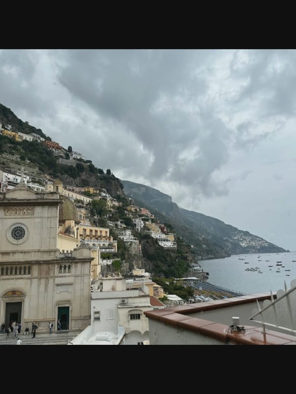 Mediterranean hillside town streets, harbor views, and a tattoo session