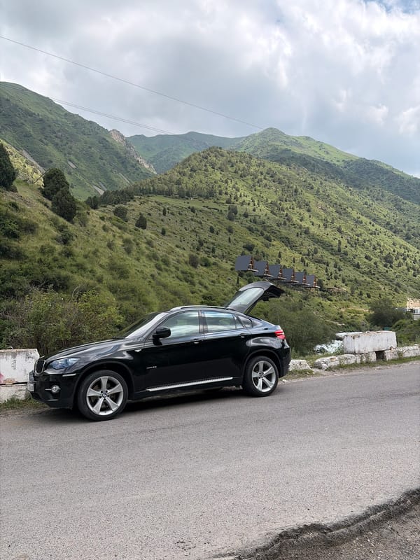 Travelers make roadside stop for water, photos in mountains