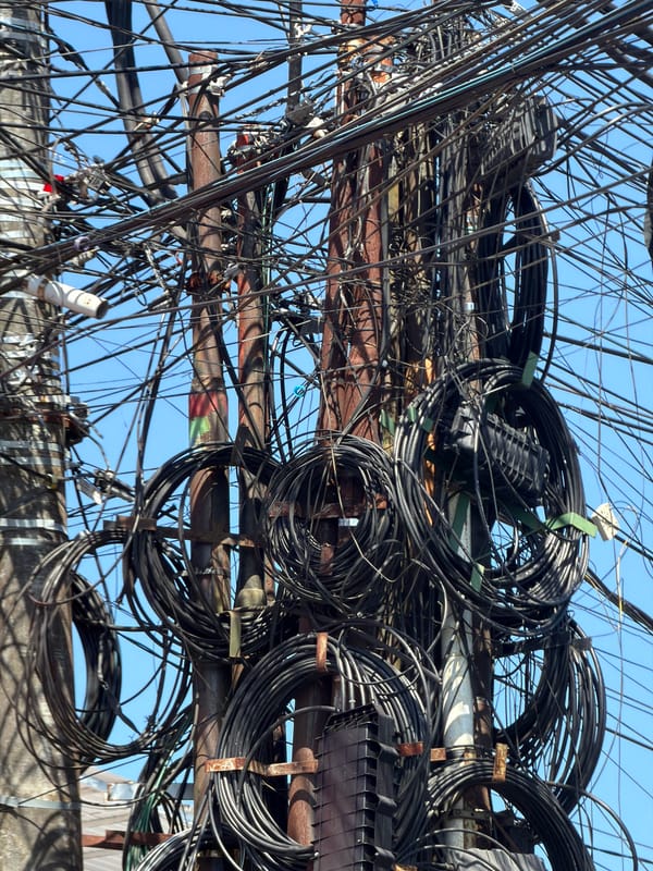 Morning commute captures Kuta Selatan's tangled utility infrastructure