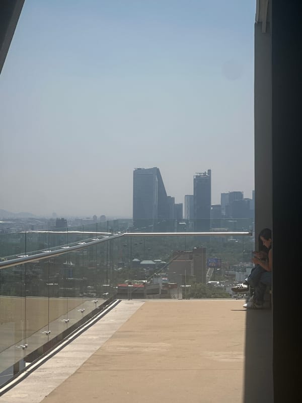 Visitors document exhibits and city views at Mexico City cultural venue