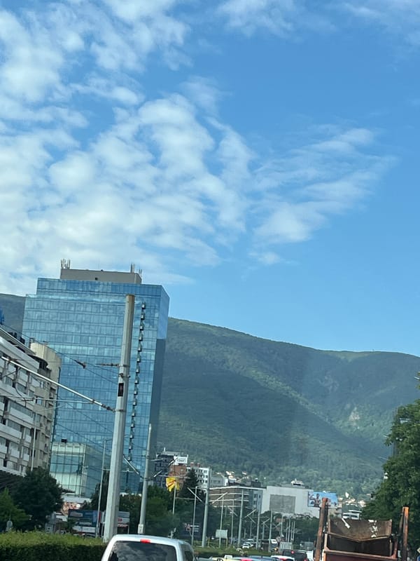 Morning drive through Sofia, monuments and mountains in view