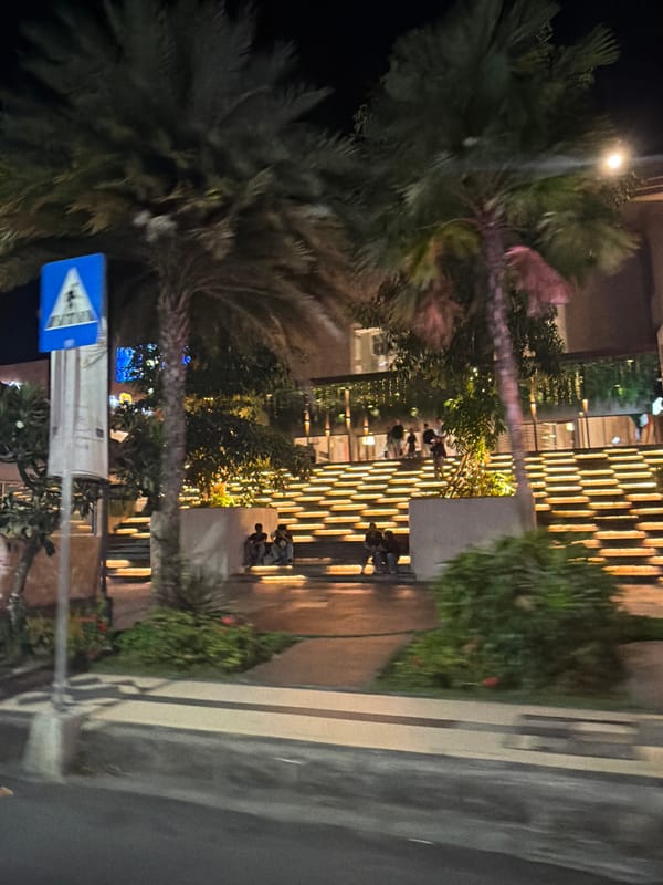 Kuta's neon-lit hotel strip on a busy night