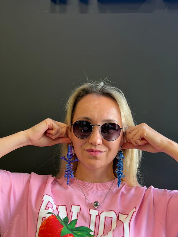 Trying on big blue earrings and making faces in Izhevsk