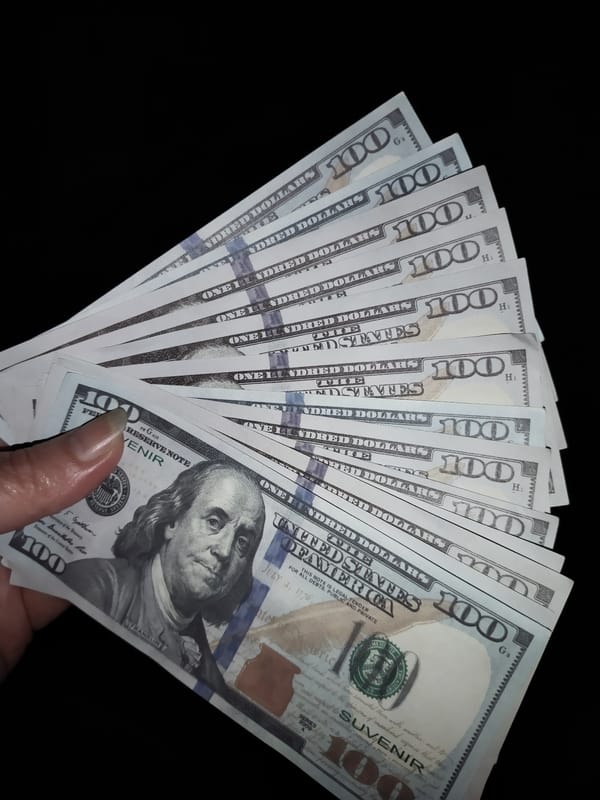 Fanned $100 bills displayed in Horishni Plavni