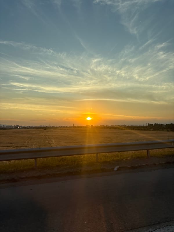 Sunset drive through Kazichene with a poodle in the passenger seat