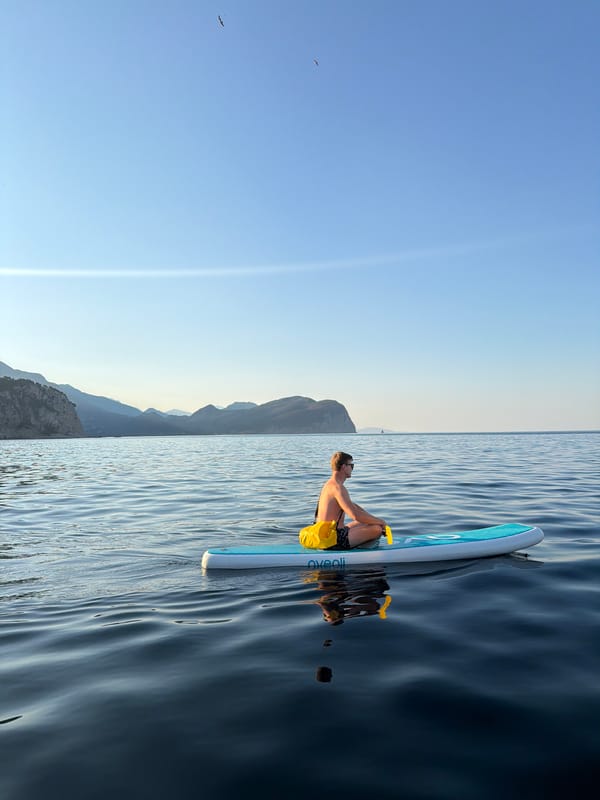 Paddleboarding around Petrovac's coastline and chapel islet