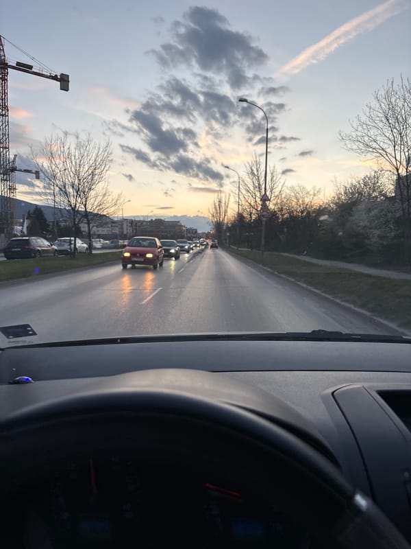 Driver documents traffic backup with red car ahead