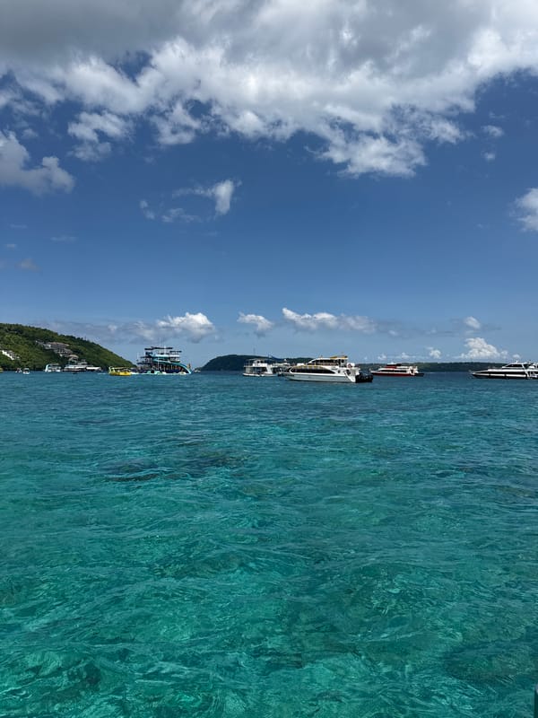 Boats anchored in turquoise waters at Kampung Toyapakeh harbor