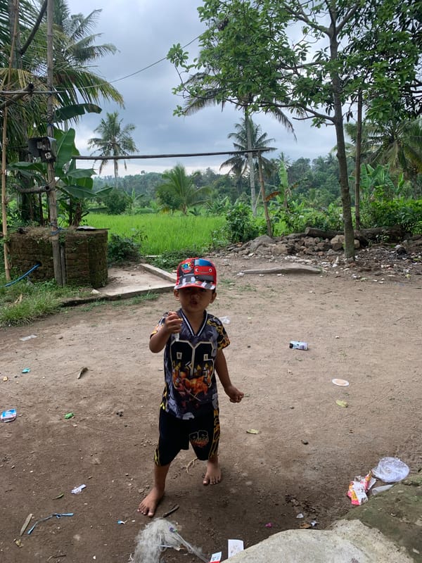 Boy documented in Indonesian village during morning hours