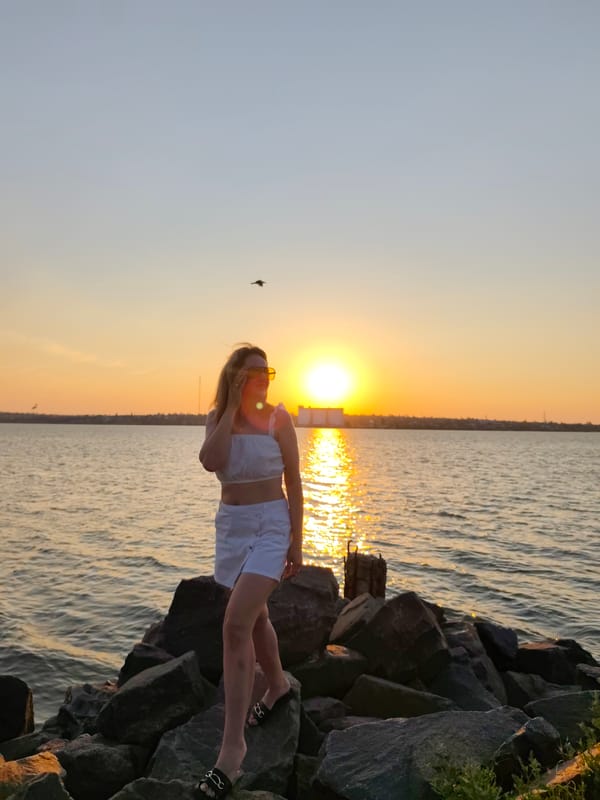 Sunset poses on Mykolaiv's rocky waterfront shore