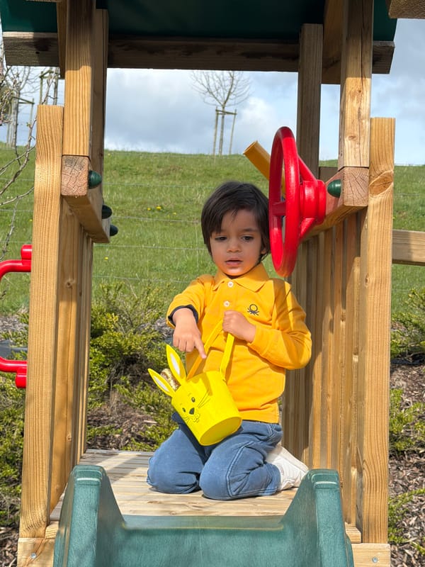 Toddler enjoys Easter candy on playground in Luxembourg