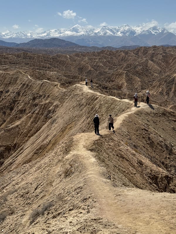 Hikers navigate steep mountain trail in Kyrgyzstan