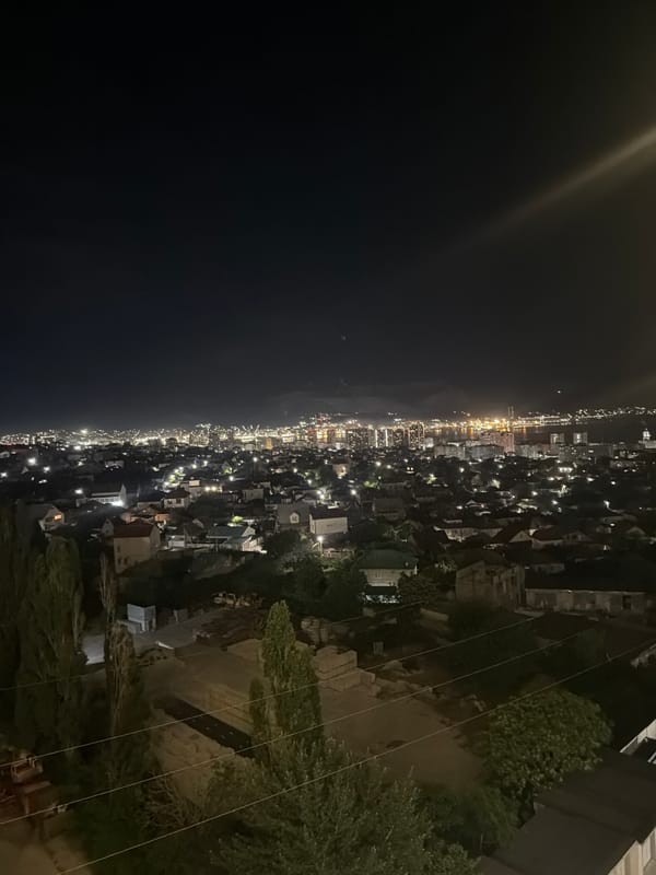 Evening scenes from Novorossiysk mixing aerial city views with indoor moments