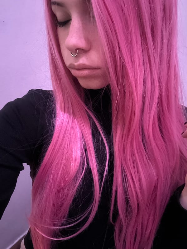 Pink-haired person and sleeping cat captured in Buenos Aires