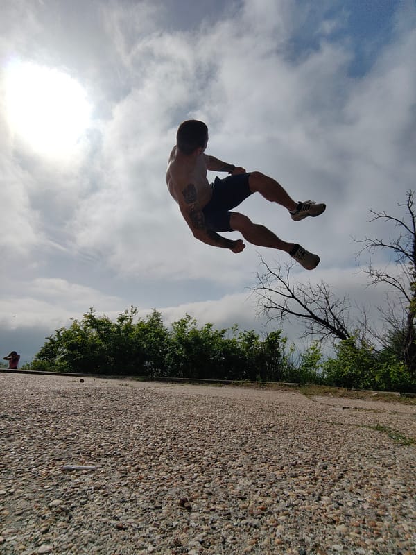 Man performs morning acrobatics near Soviet friendship monument in Varna