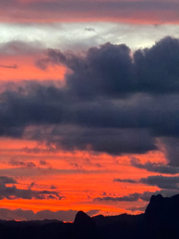 Dramatic sunset sky over Vang Vieng's karst landscape