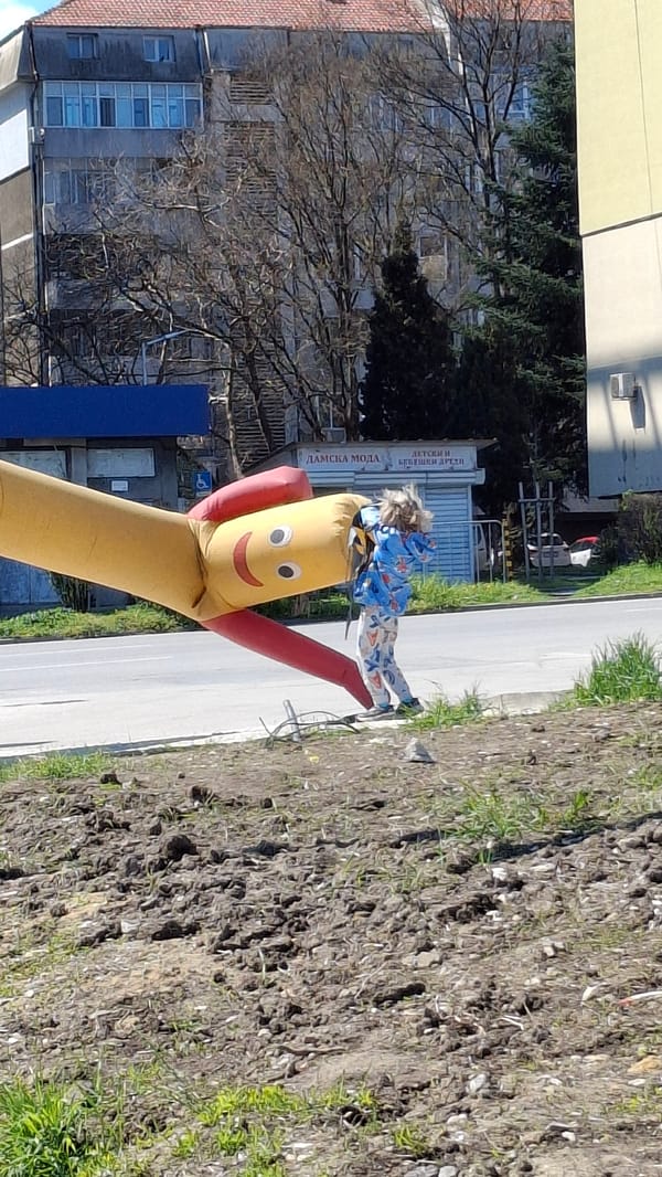 Child plays with inflatable advertising figure in Varna