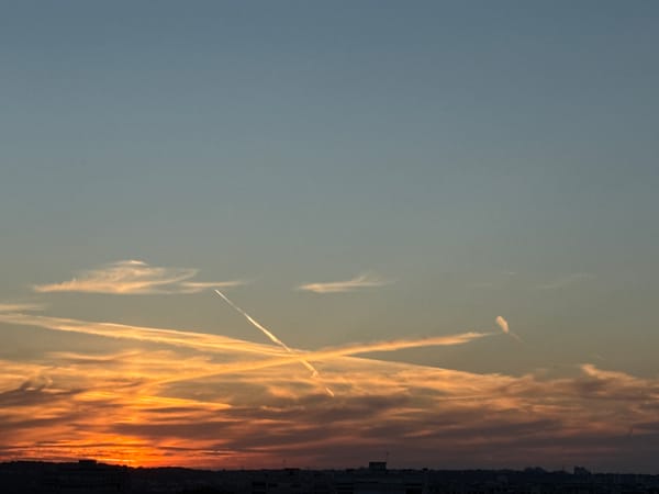 Vivid urban sunset, clouds and skyline at golden hour