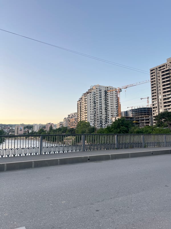 Sunset views across Tbilisi from elevated roads and bridges
